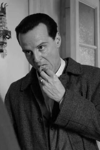 Tom Ripley, played by Andrew Scott, is seen licking a stamp in the Netflix drama series 'Ripley'