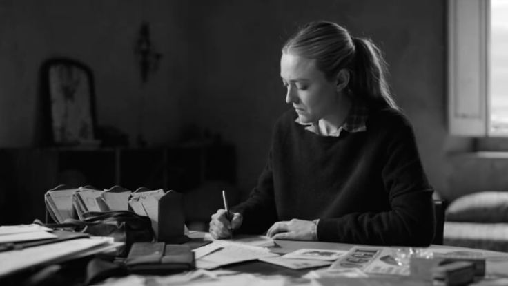 Marge Sherwood, played by Dakota Fanning, is seen writing a letter in the Netflix drama series 'Ripley'